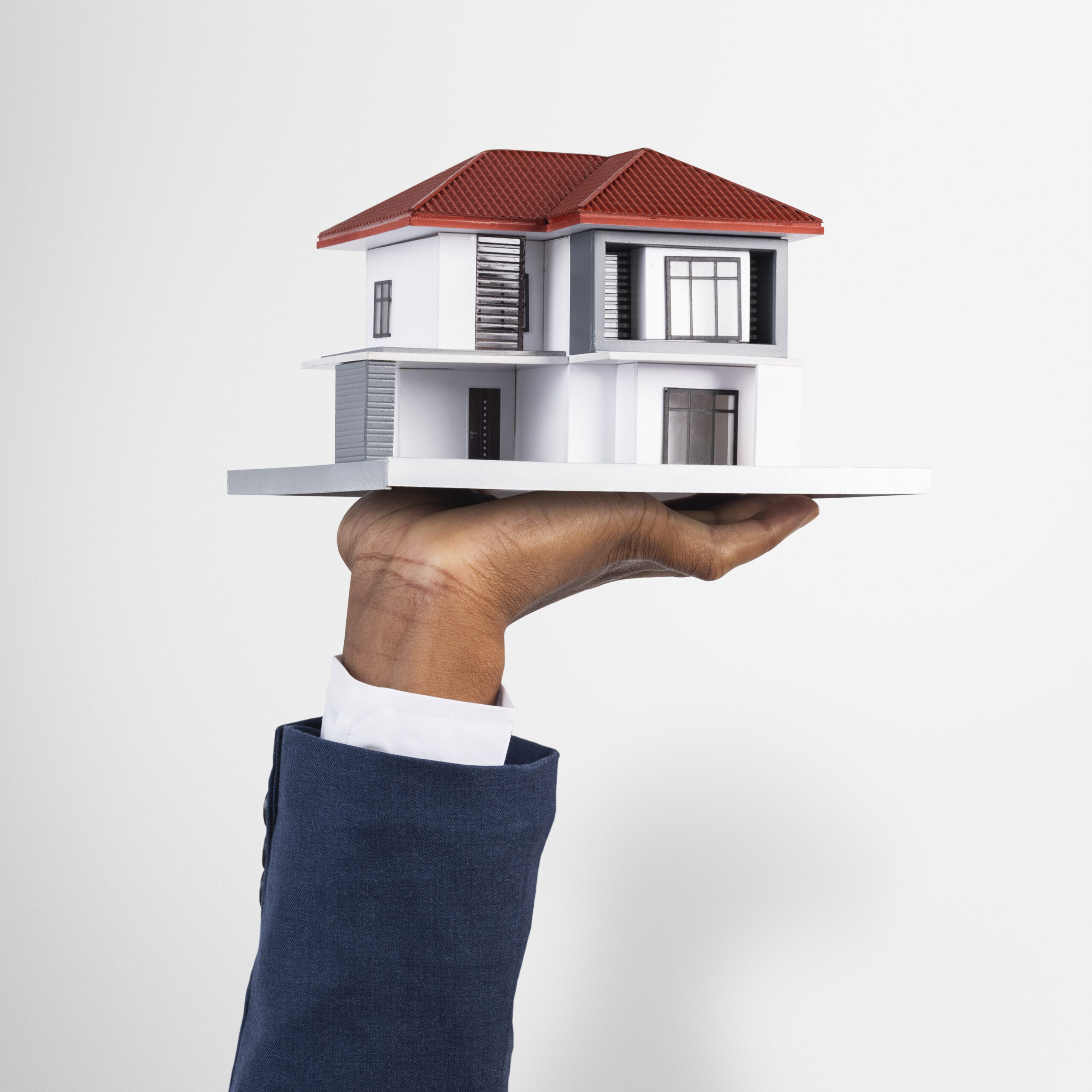 hand holding house real estate property model 1 scaled